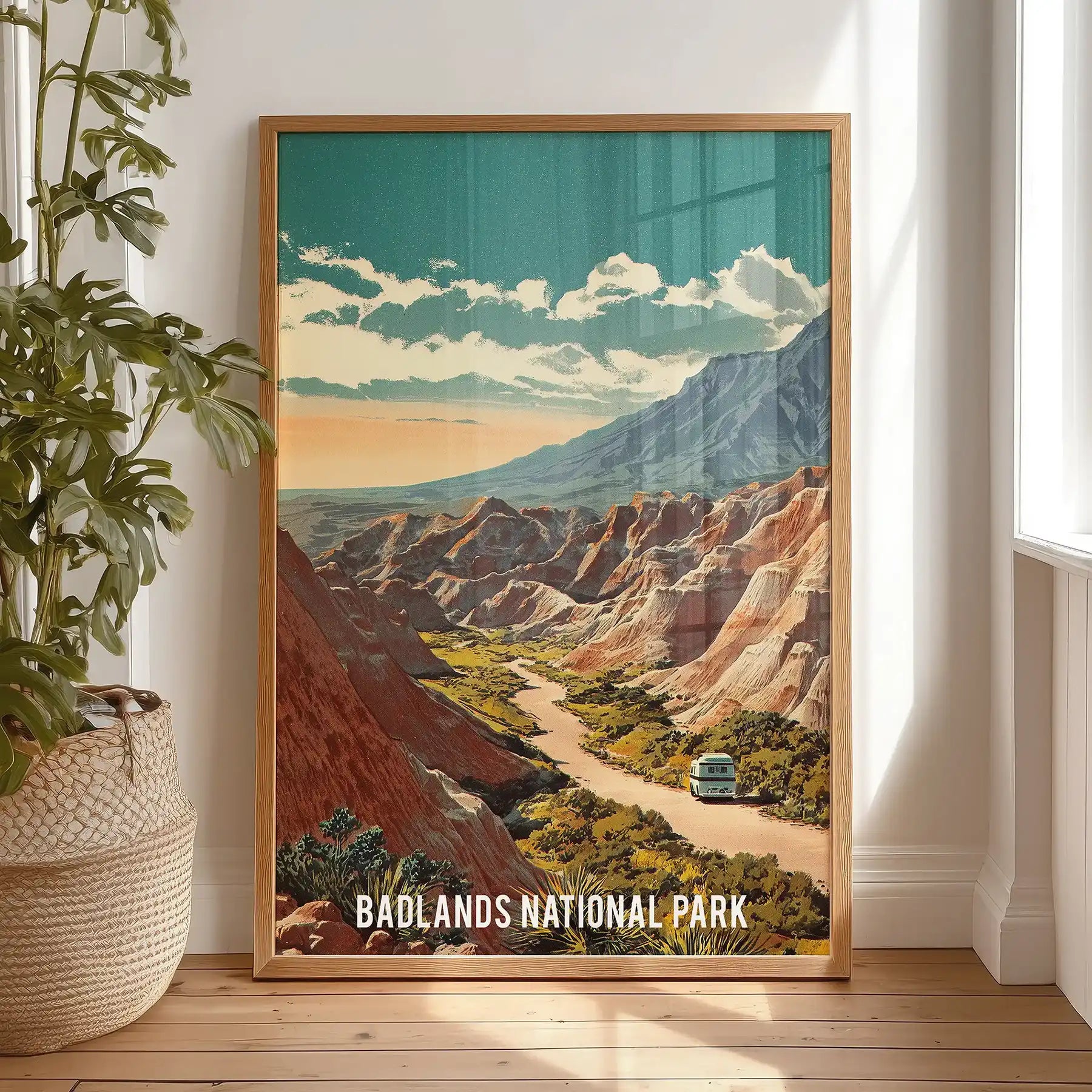Beige and blue mountain ridges wall print warms the bedroom, set in a light wood frame and shown standing against the wall for a relaxed look.