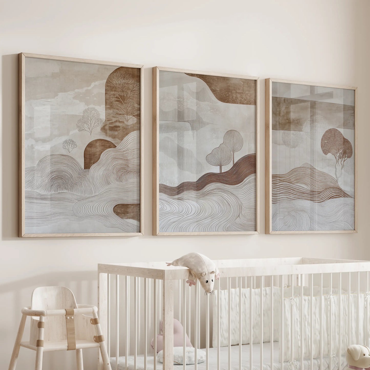 A set of three minimalist beige and brown prints in oak frames softens the baby room above the bassinet with soothing neutral tones.