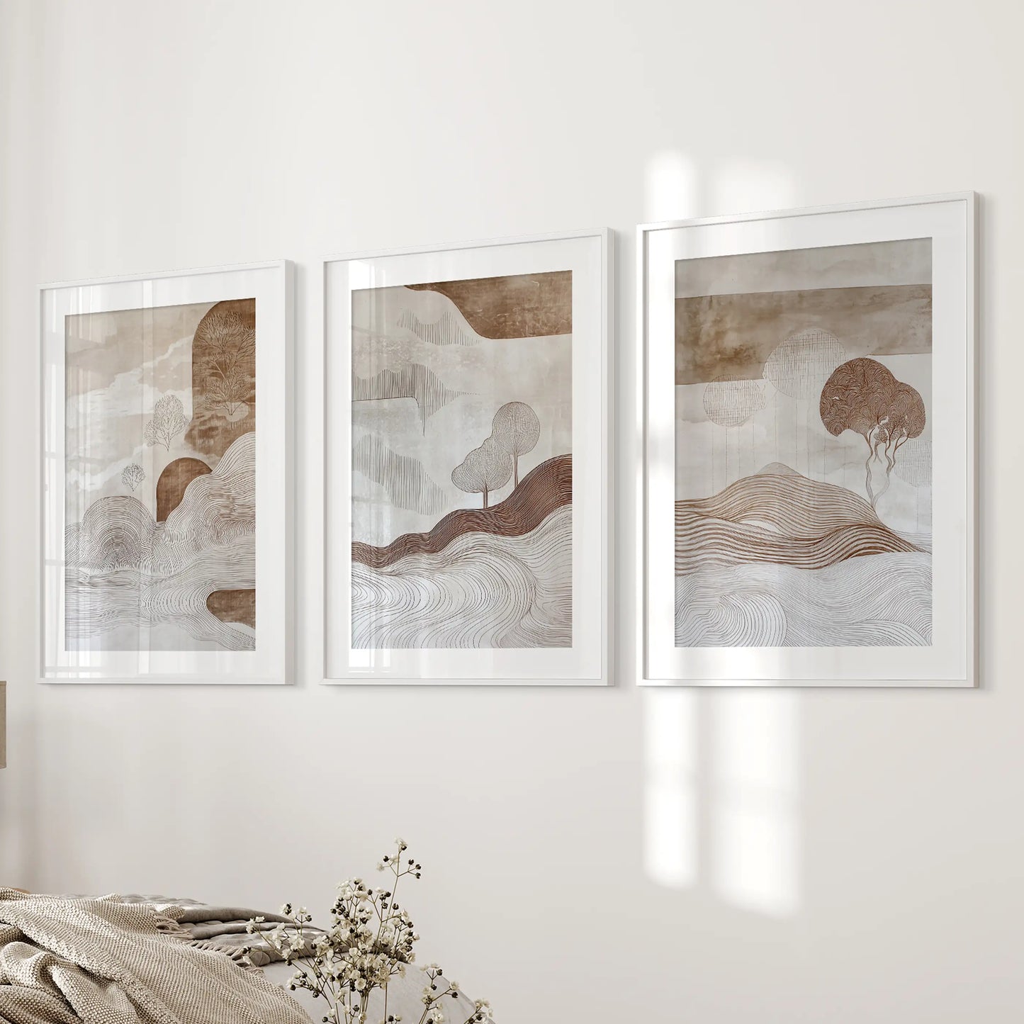 Wabi-sabi line art in a white-matted frame trio introduces understated wall art to the bedroom’s bedside wall for a calm accent.