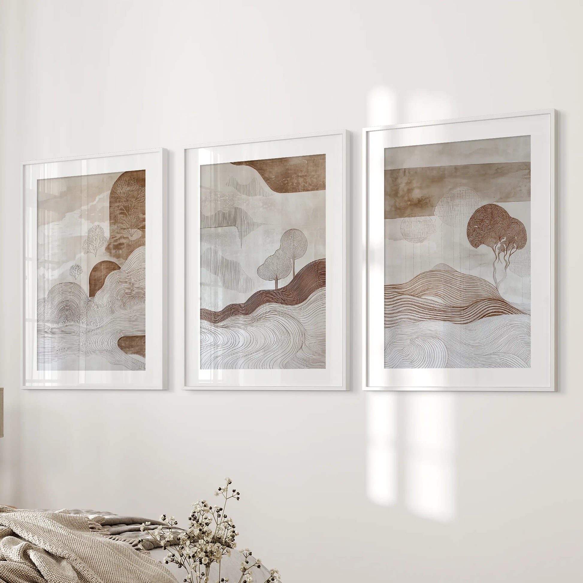Wabi-sabi line art in a white-matted frame trio introduces understated wall art to the bedroom’s bedside wall for a calm accent.