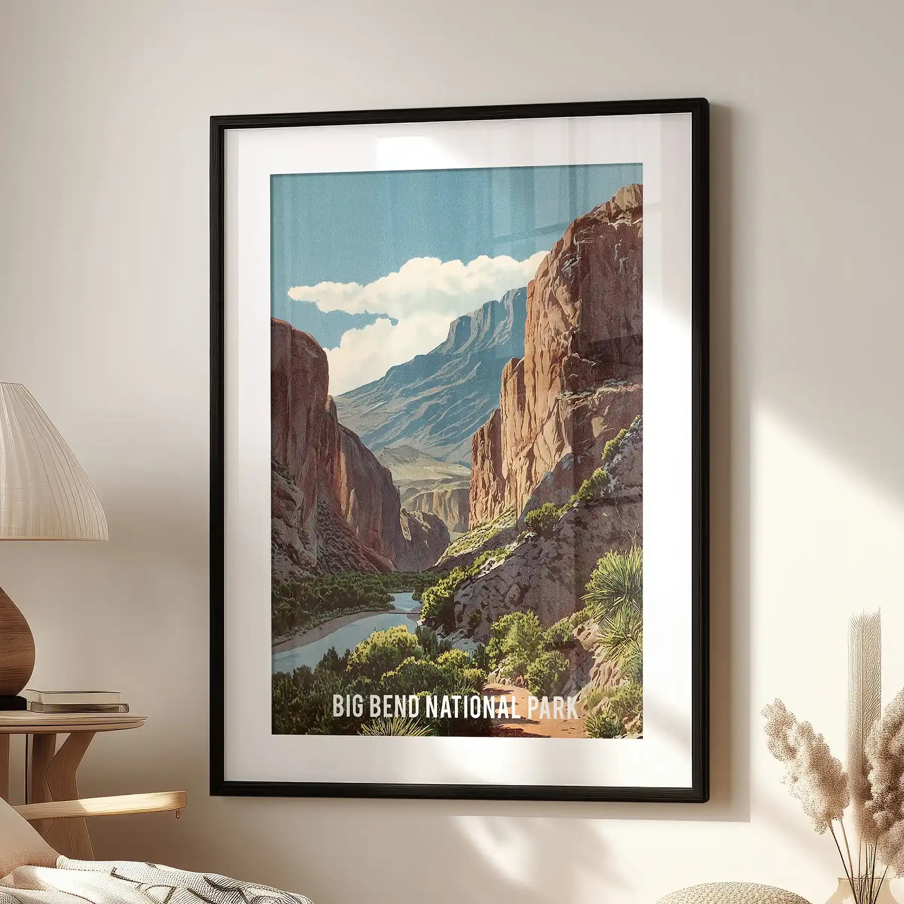 A single Rio Grande canyon poster framed in black with a mat rests near an accent chair, its blue-brown tones adding a crisp travel feel.