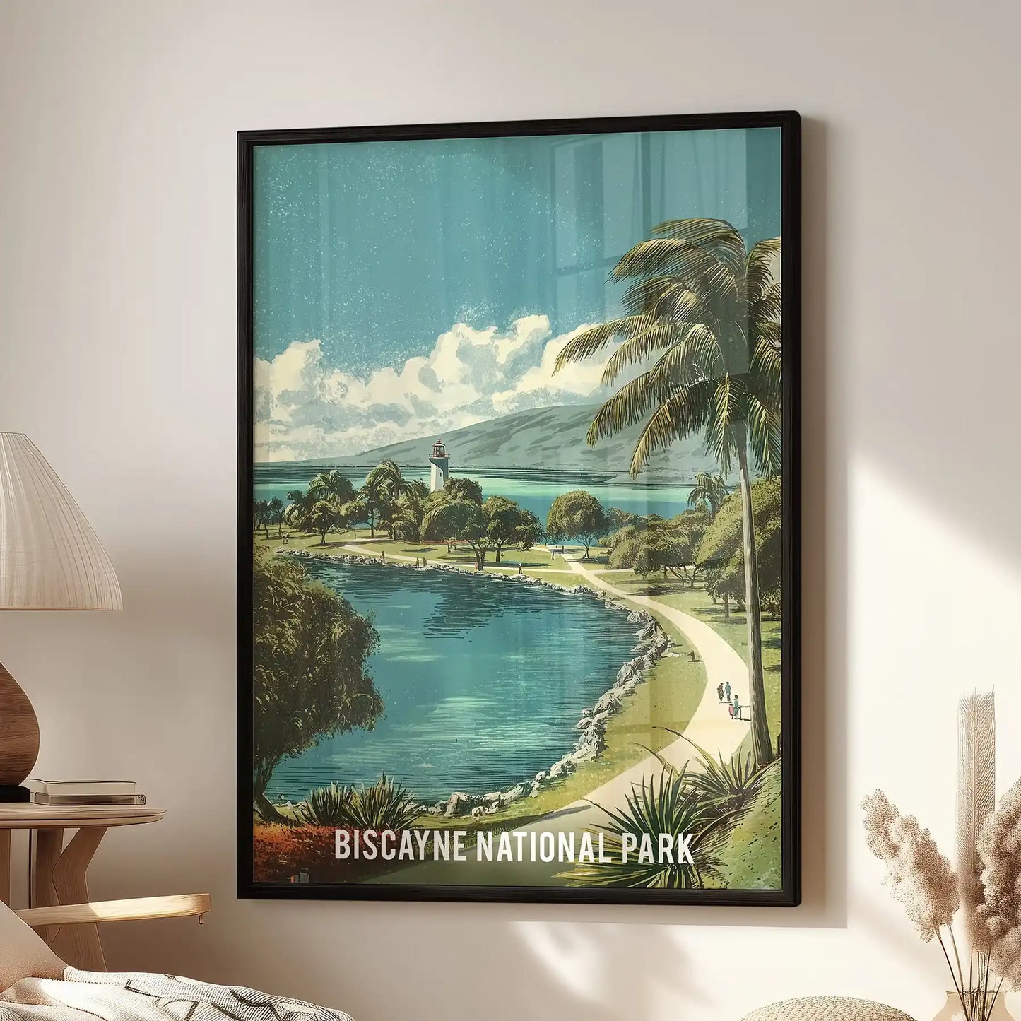Biscayne National Park home wall art print in a black frame sits beside a living room reading chair, showing a retro bay scene with lush green shoreline.