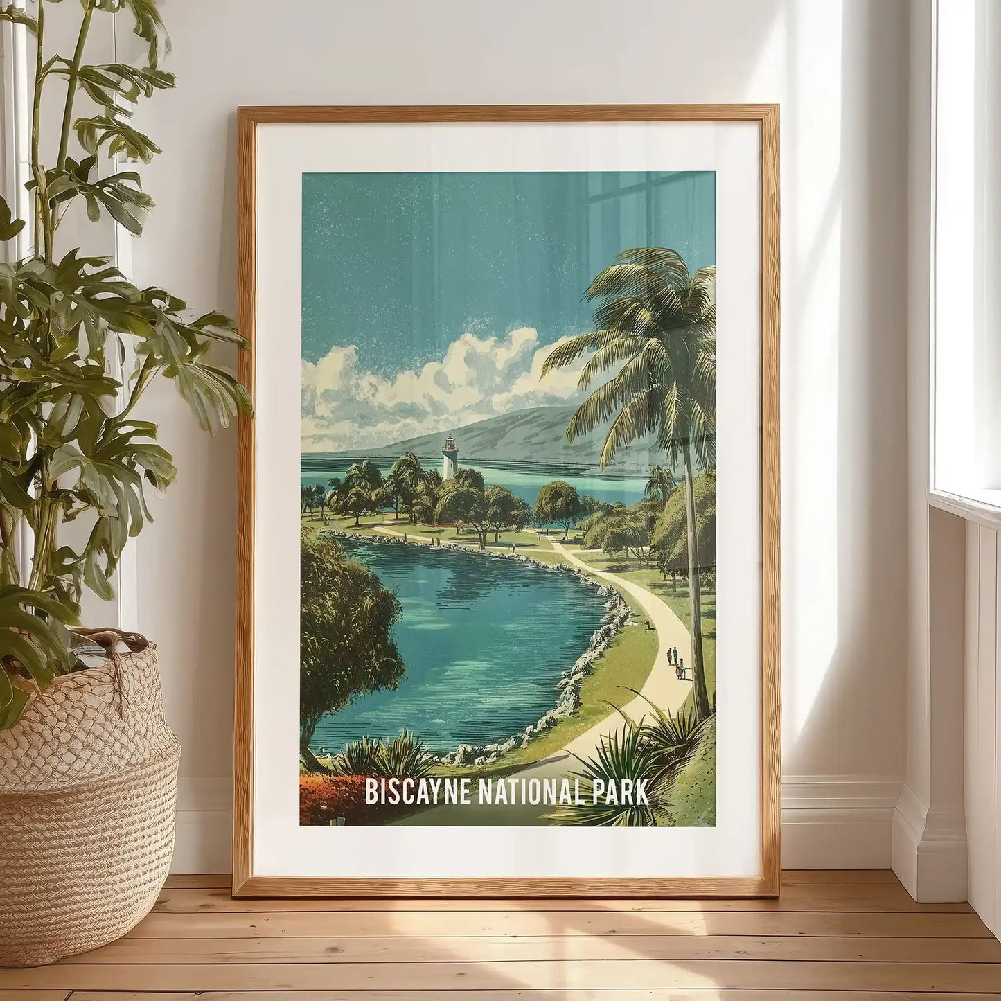 A black-framed coastal landscape print, matted and resting on the bedroom floor, portrays Biscayne’s clear bay water and soft retro shoreline.