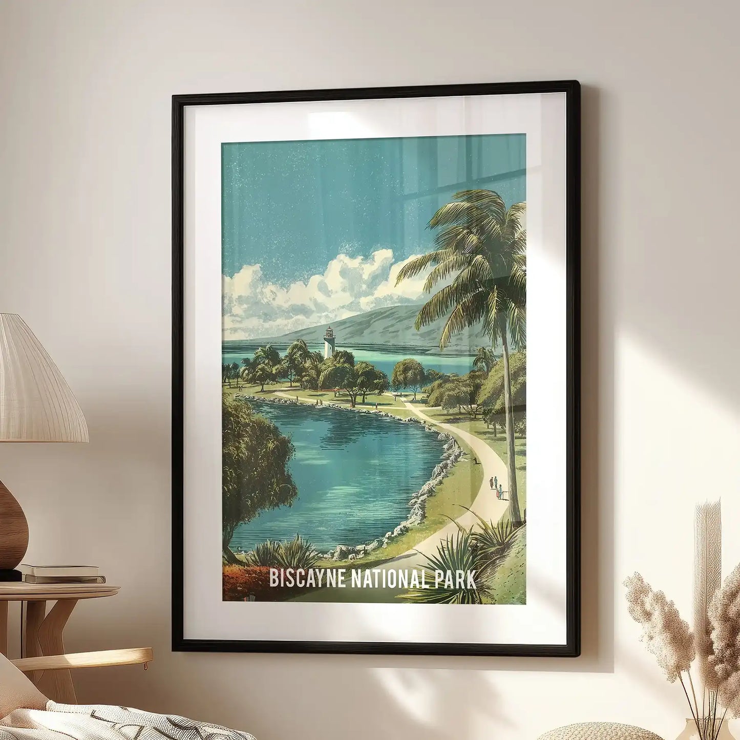 Biscayne Bay shoreline wall picture print, matted in a black frame, hangs above a family-room lounge chair with a vintage tropical coast palette.