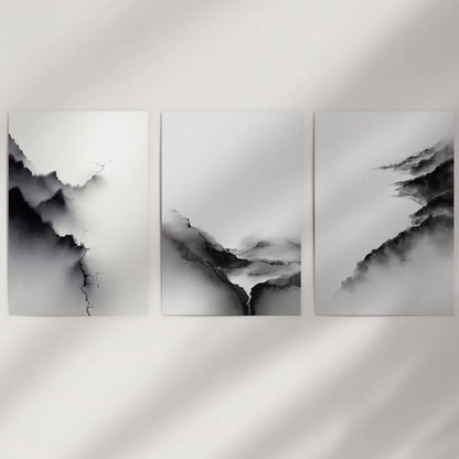 Three unframed poster prints feature monochrome abstract landscapes, bringing a crisp graphic calm to a plain wall.
