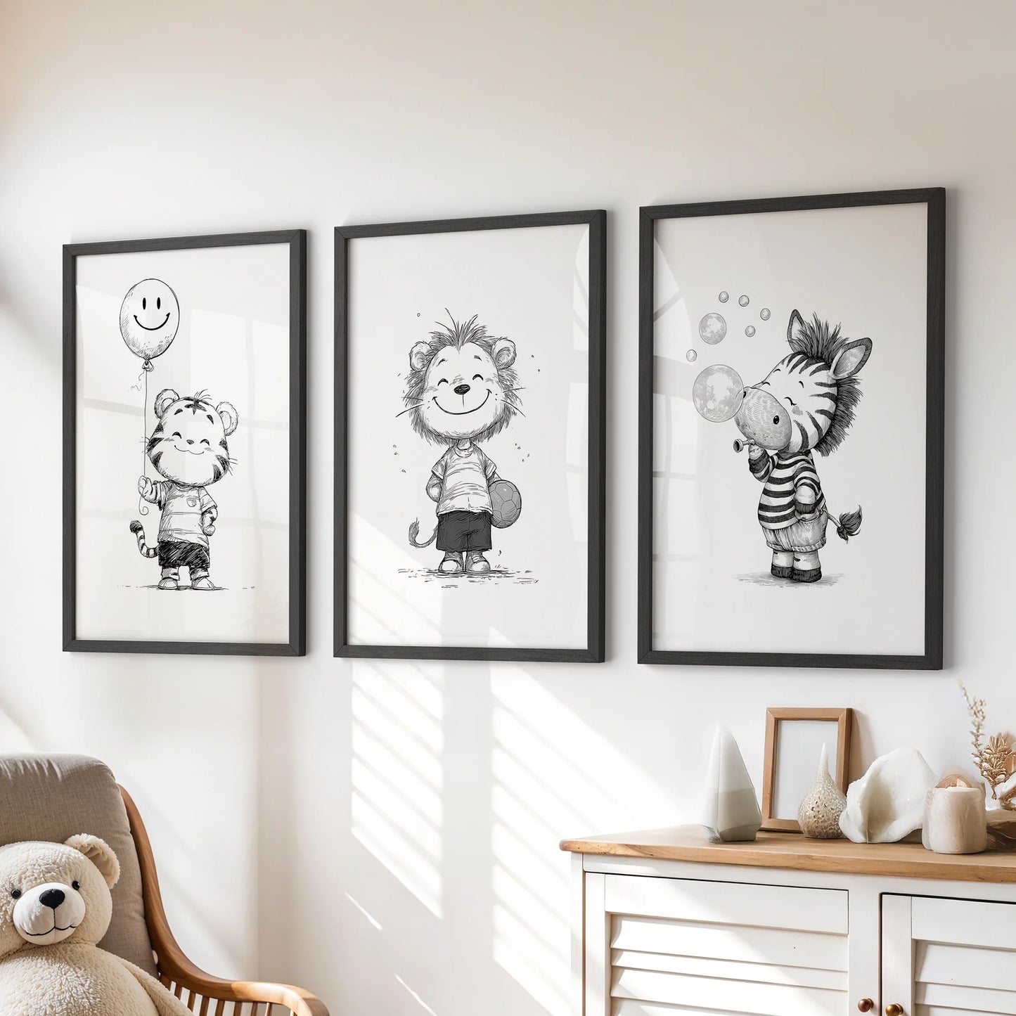 Three black-framed prints of safari animals decorate the kids room above a chest of drawers, giving the space a playful, monochrome touch.