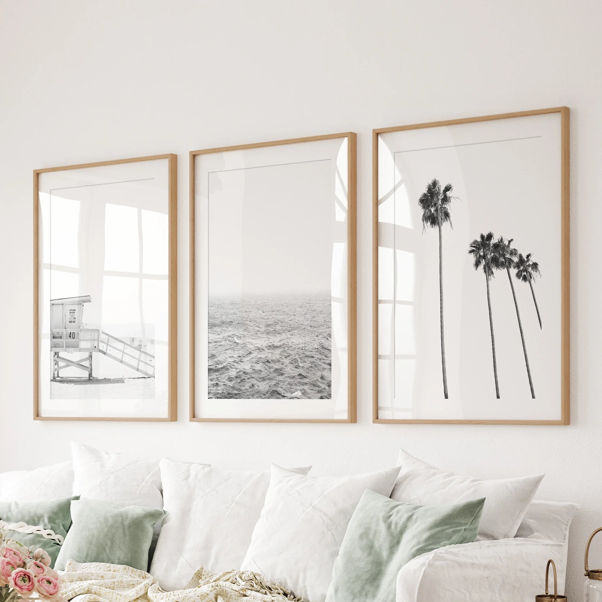Lifeguard tower on the beach, a 3-piece canvas wall art series, stretches above the bedroom headboard in wrapped prints for a bold, graphic coastal touch.