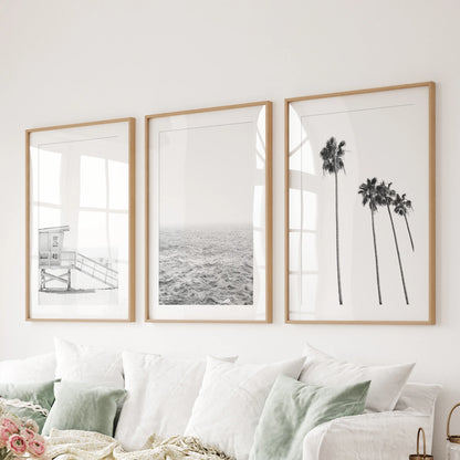 Lifeguard tower on the beach, a 3-piece canvas wall art series, stretches above the bedroom headboard in wrapped prints for a bold, graphic coastal touch.