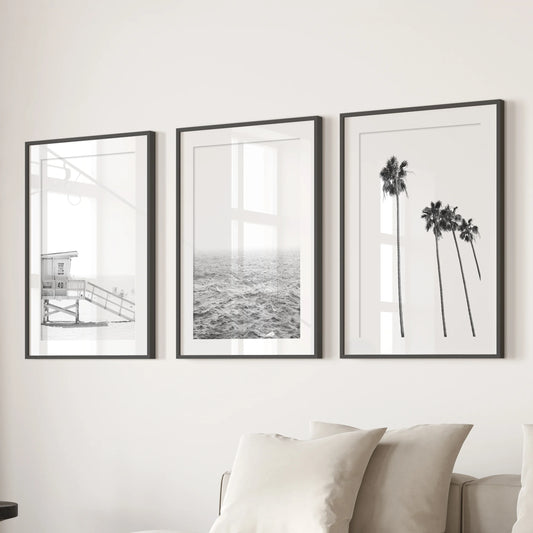 Beach cabin, a set of three wall pictures, arrives in black-mat frames and lines the family room wall behind the couch for laid-back coastal charm.