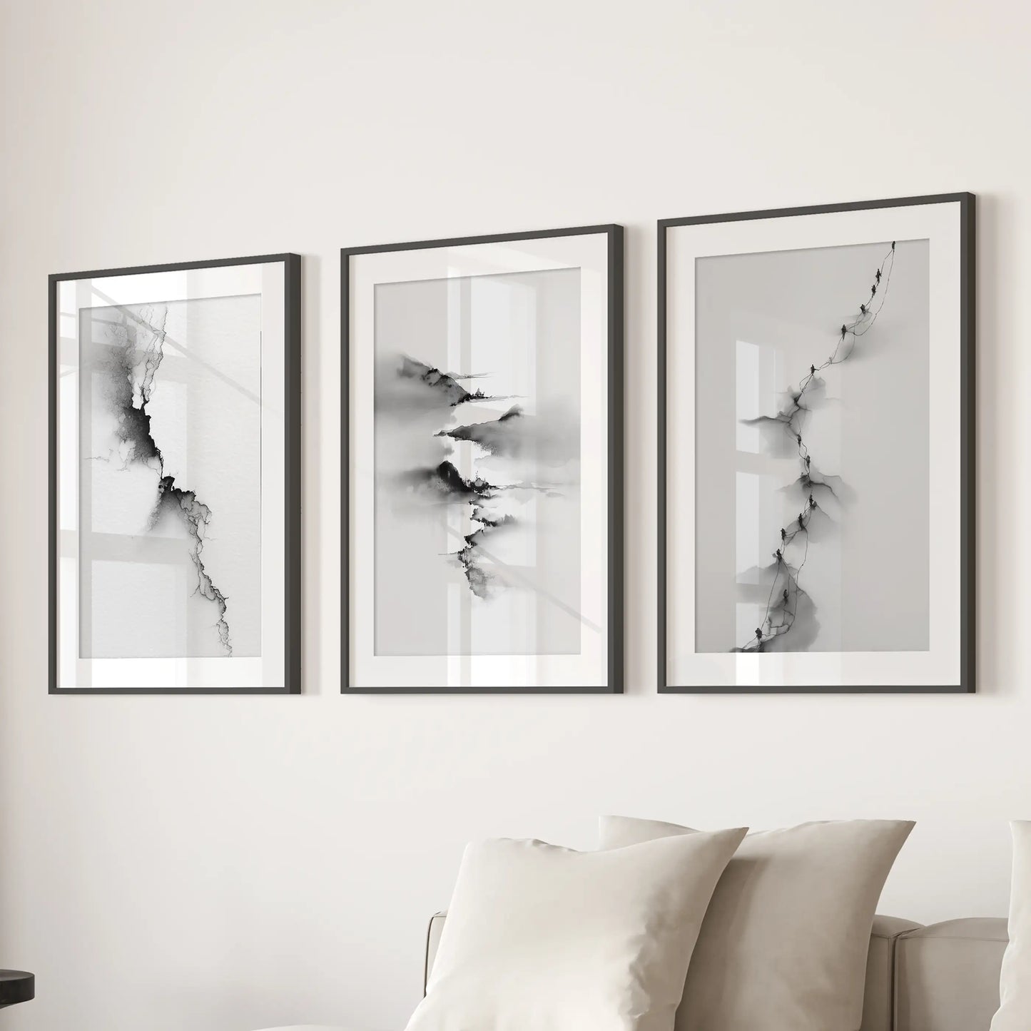 This trio of minimalist nature prints, matted within black frames, spans the wall above the sofa, giving the living room balanced symmetry.