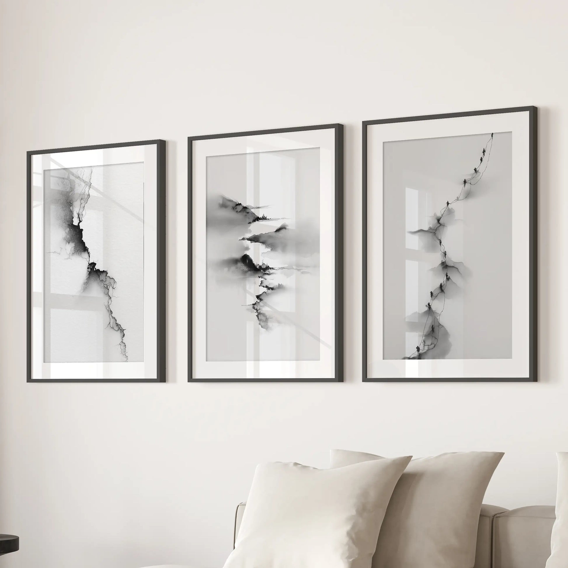 This trio of minimalist nature prints, matted within black frames, spans the wall above the sofa, giving the living room balanced symmetry.