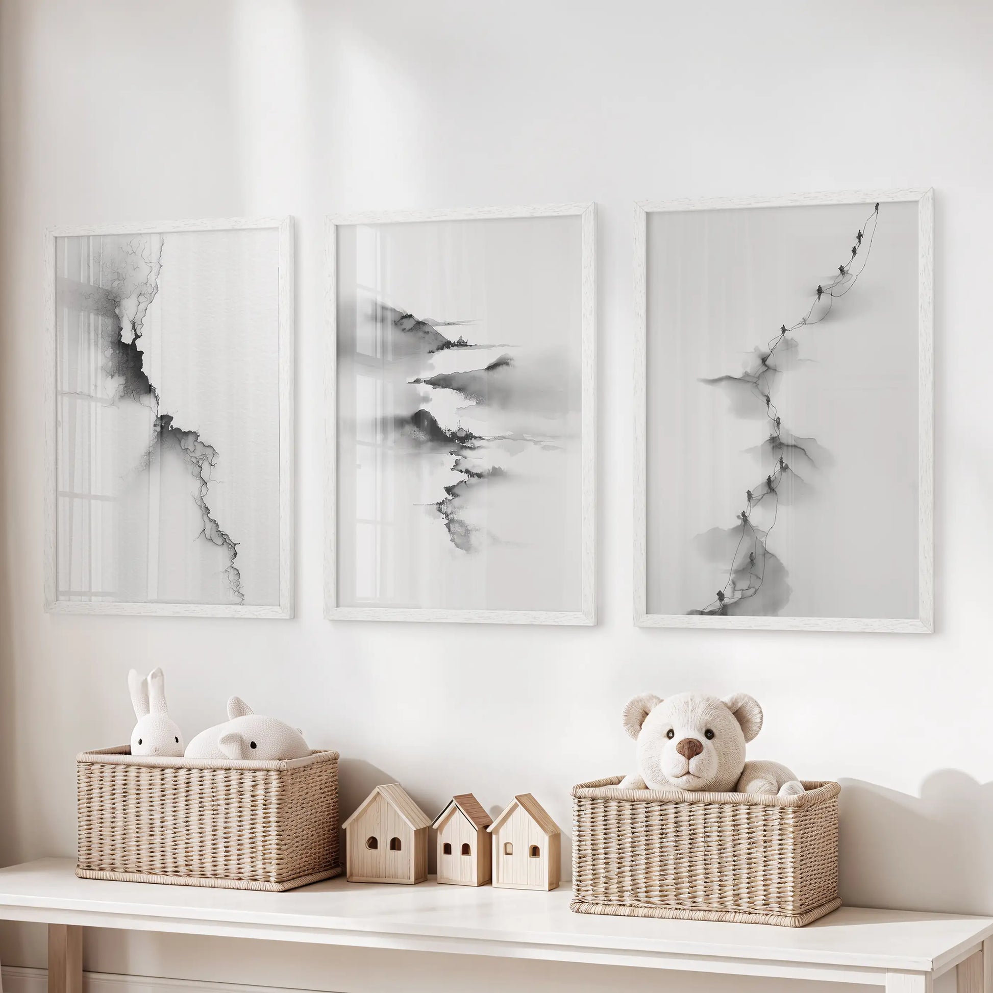 Modern monochrome scenery art, a set of three art prints in white frames, hangs above the toy organizer to add polish to the playroom.