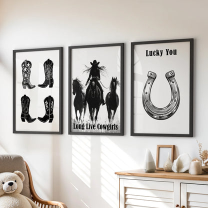 Black-and-white horseshoe art prints, a playful three-piece wall set, hang above the playroom dresser in polished black frames.