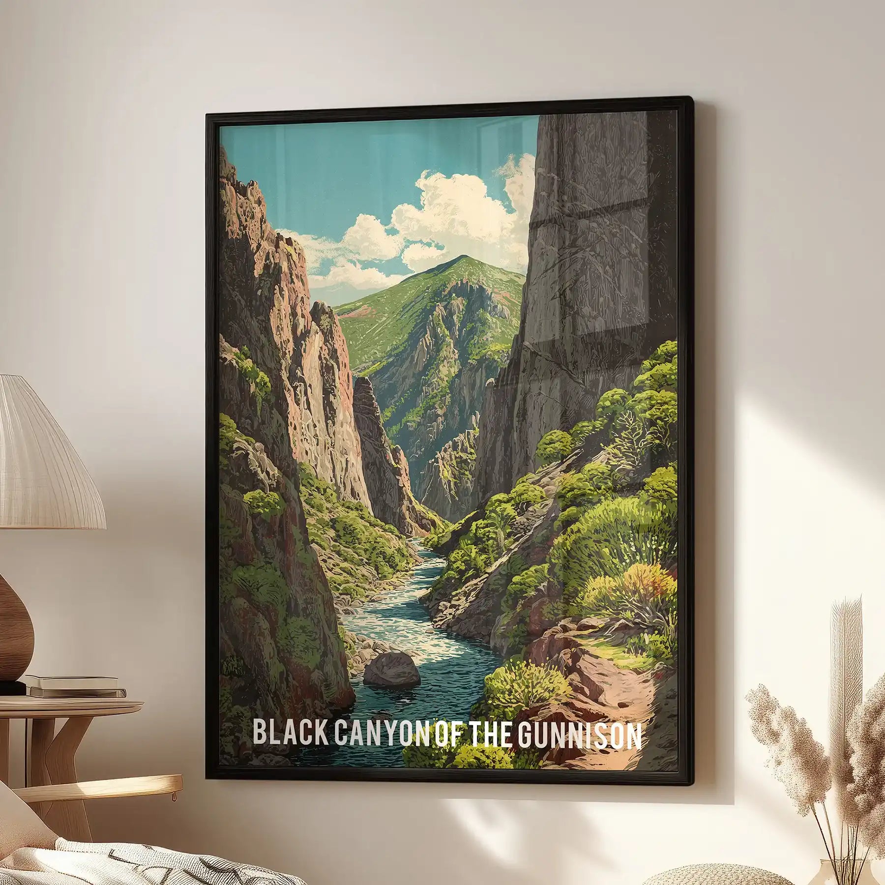 Green Colorado mountain landscape wall art print in a black frame brings a relaxed, outdoorsy mood to a living room, shown hanging over a reading chair.