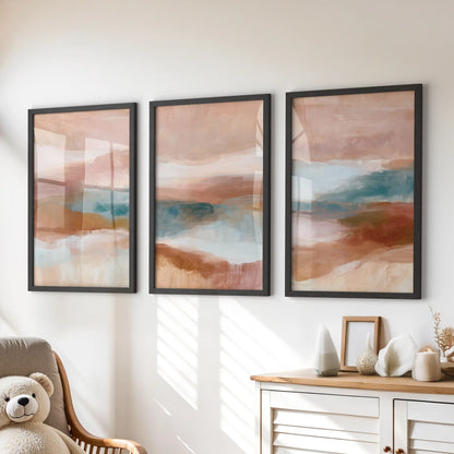 Blush pink, terracotta and blue color fields, a three-piece wall art set in slim black frames, brighten the kids playroom above the dresser.