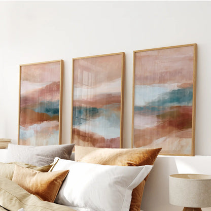 Textured minimalist forms, a set of three art prints in warm wood frames, sit over the bedroom headboard and add a soft hit of color.