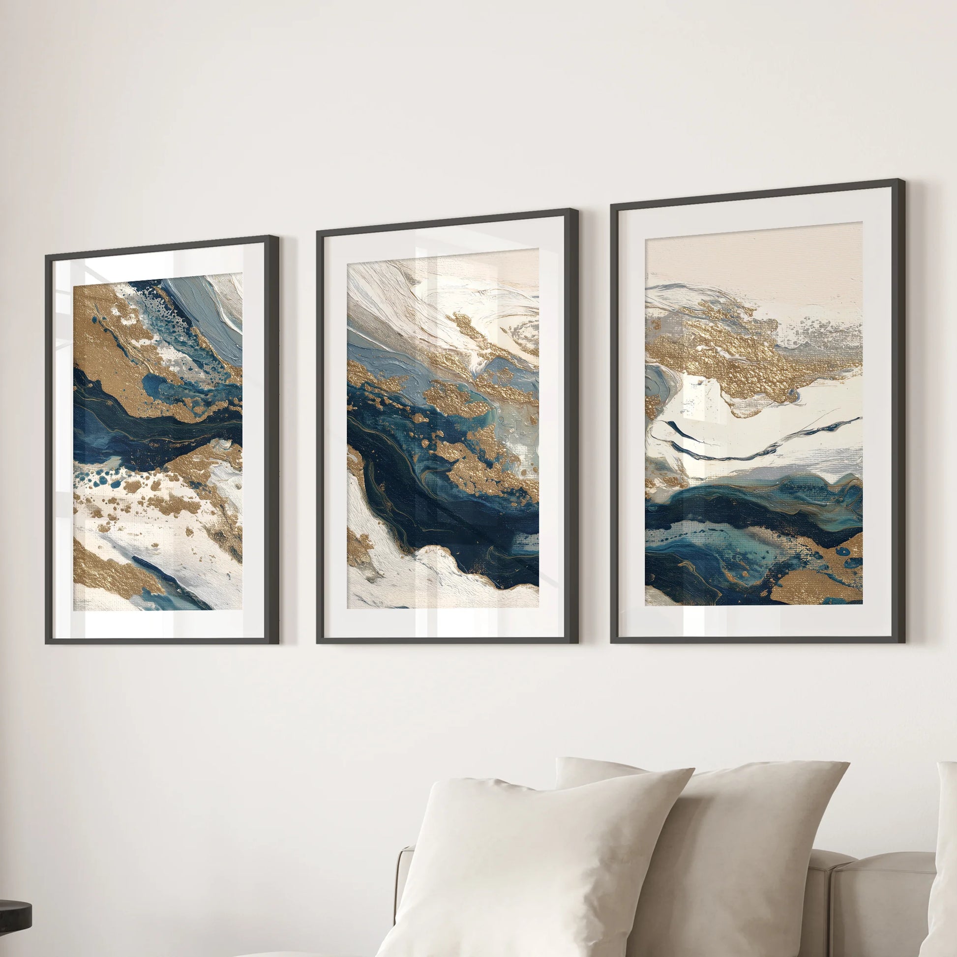 Blue and beige color fields, a wall art triptych, hang over the living room sofa in black frames with mats, bringing a crisp, gallery-style finish.