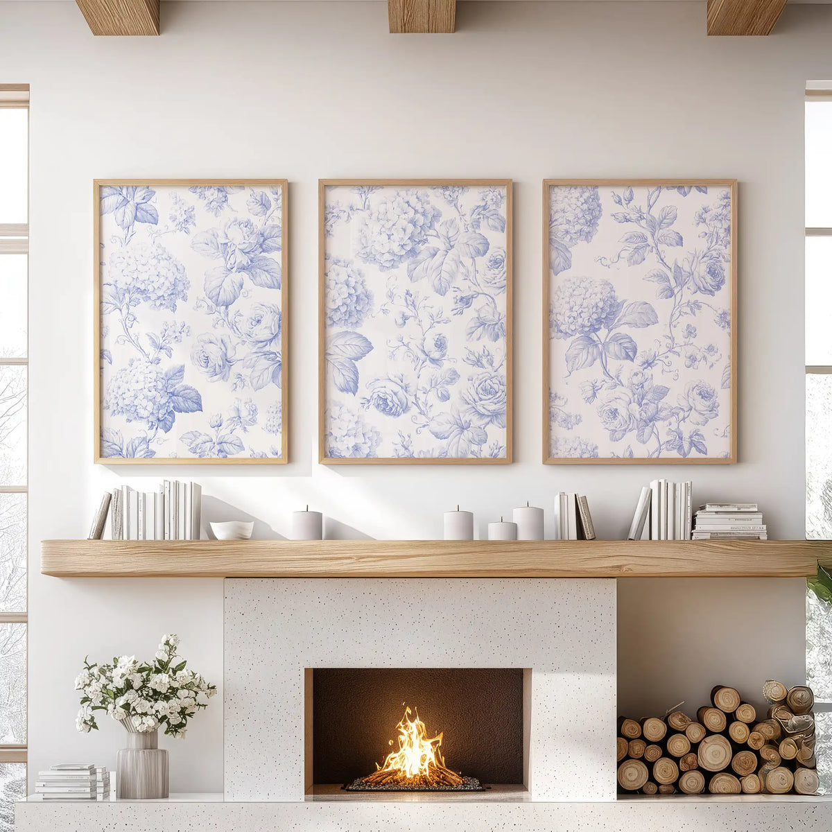 Blue roses and hydrangea clusters are interwoven with fine leaves on cream grounds in three oak-framed prints above a fireplace.