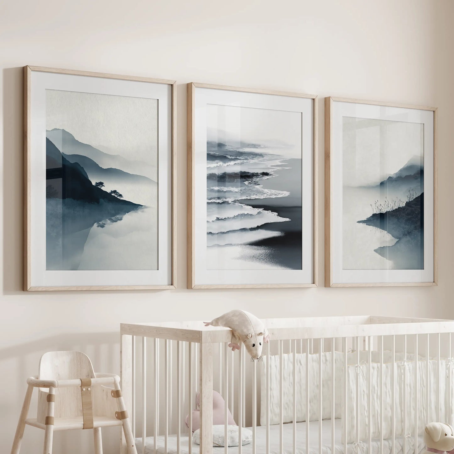 Serene beach horizon wall art set of three hangs over the crib in the nursery, matted in natural wood frames for soft, organic texture.