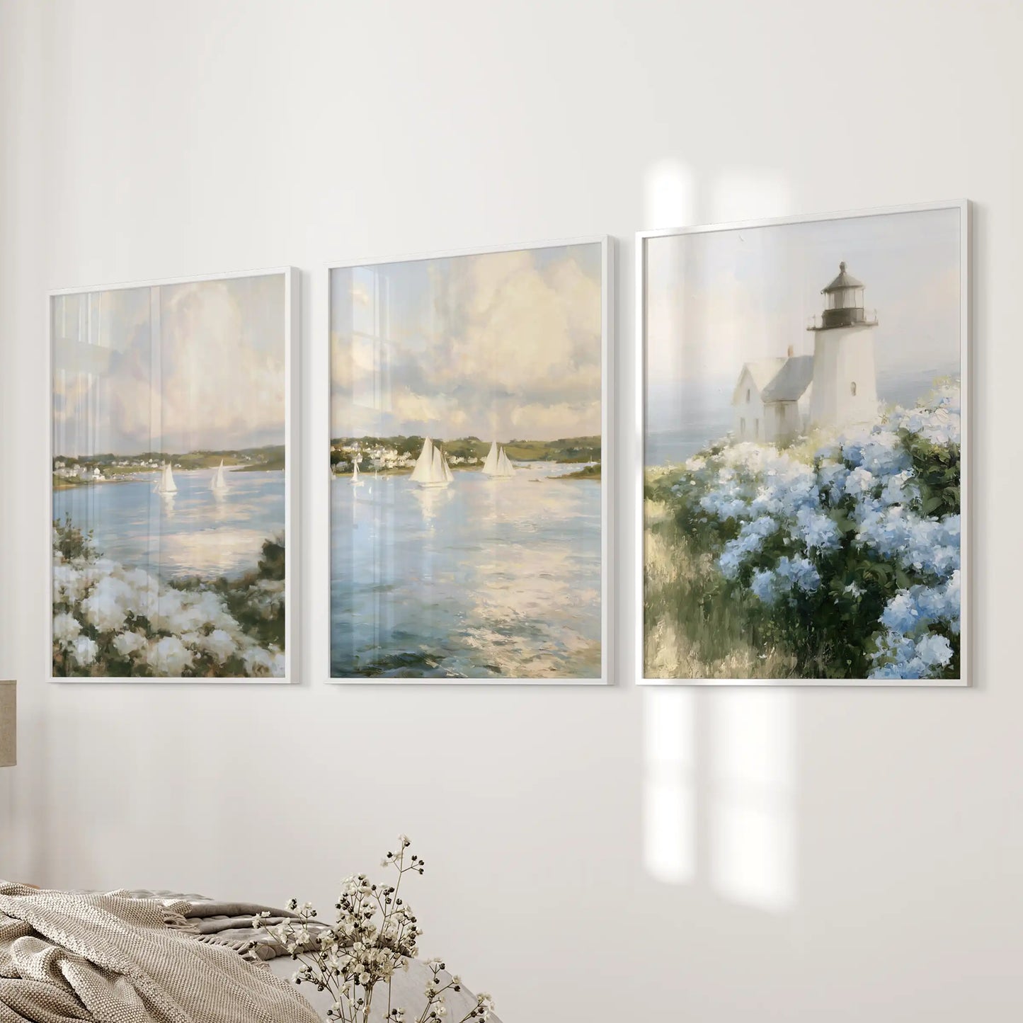 Wall decor presents a Cape Cod lighthouse as a 3-piece set in crisp white frames, adding seafaring character to a bedroom feature wall.