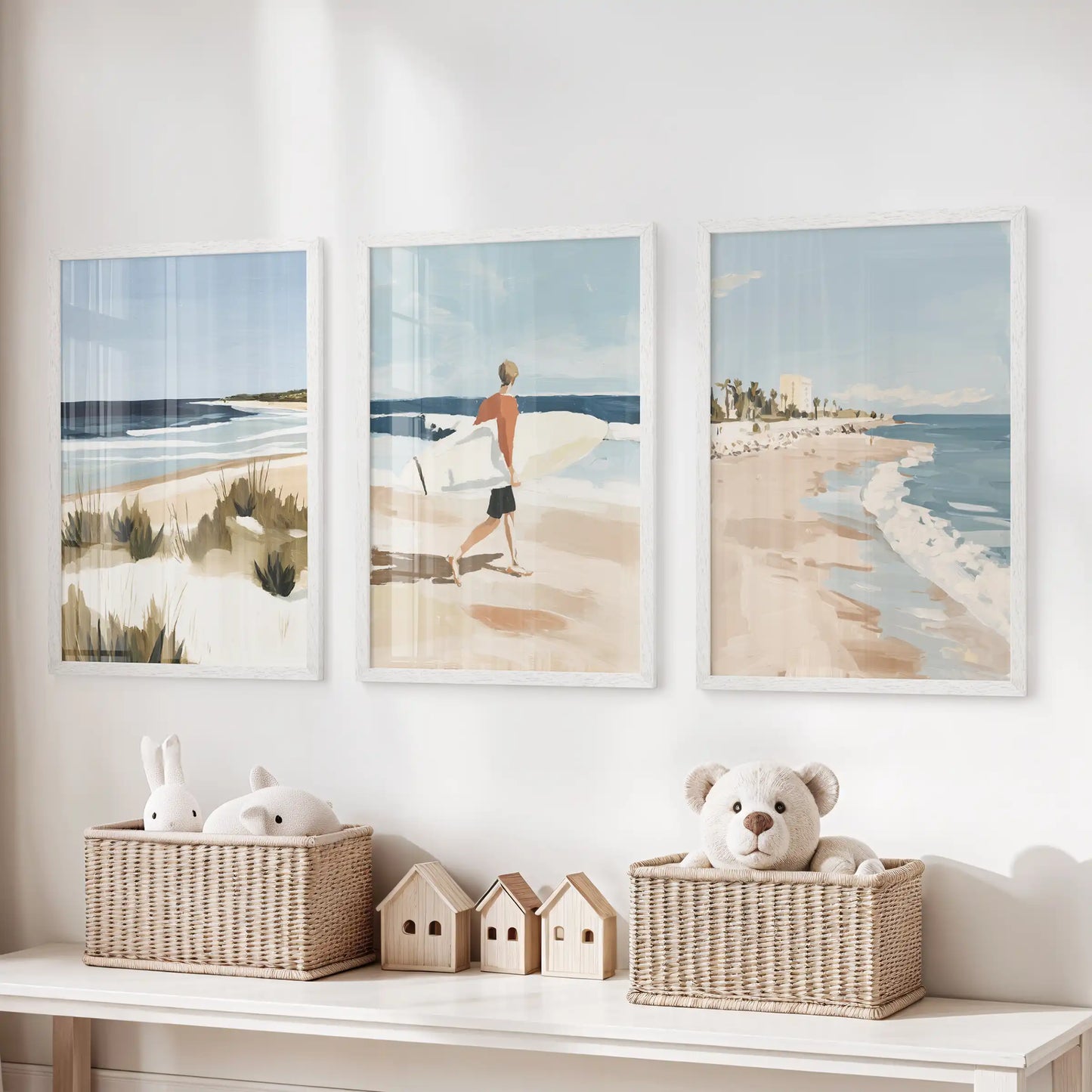 Seaside horizons, a 3-piece picture set in white frames, hangs over the playroom toy storage bench and brightens the nook with sky blues.