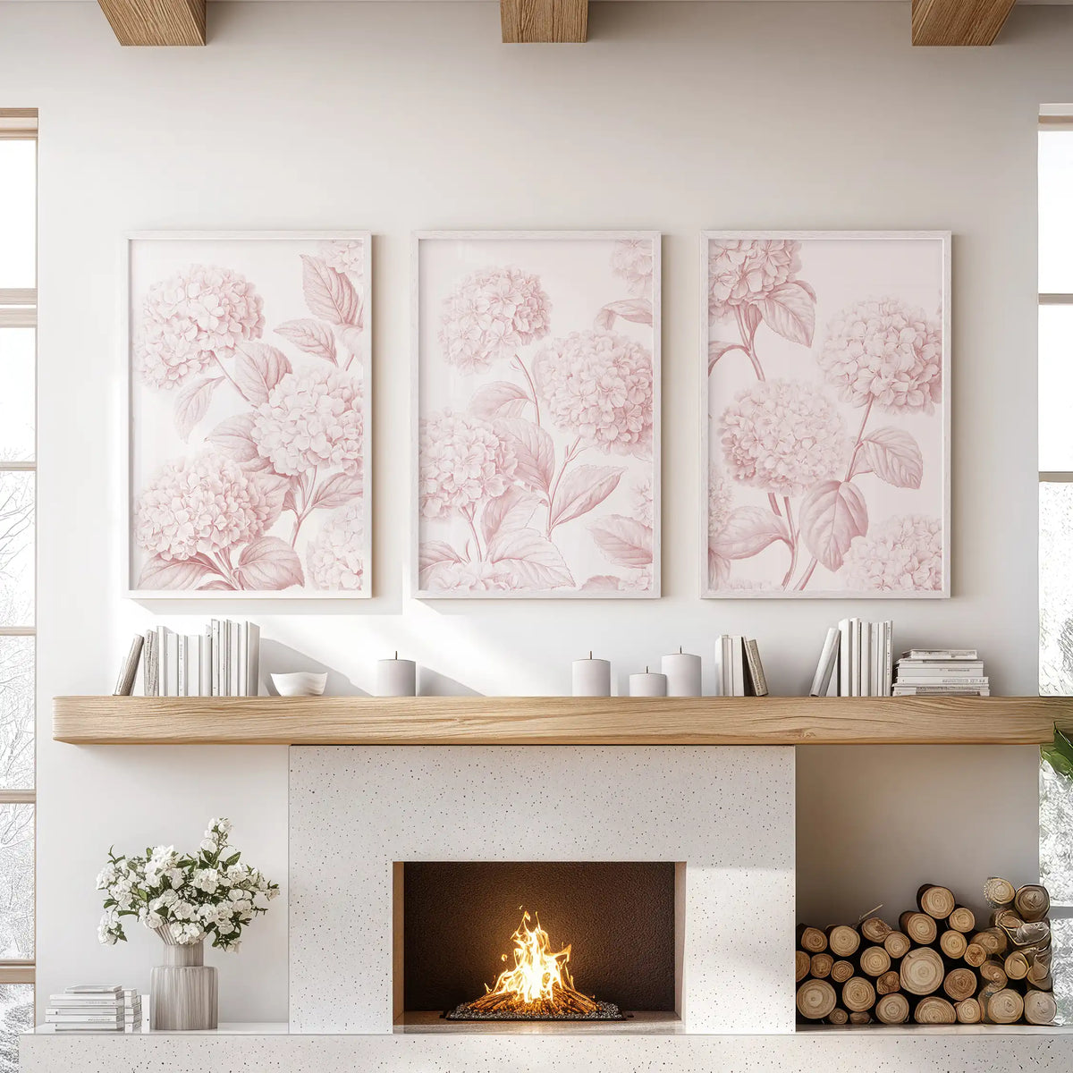 Blush pink hydrangeas fill three white-framed prints above a fireplace.