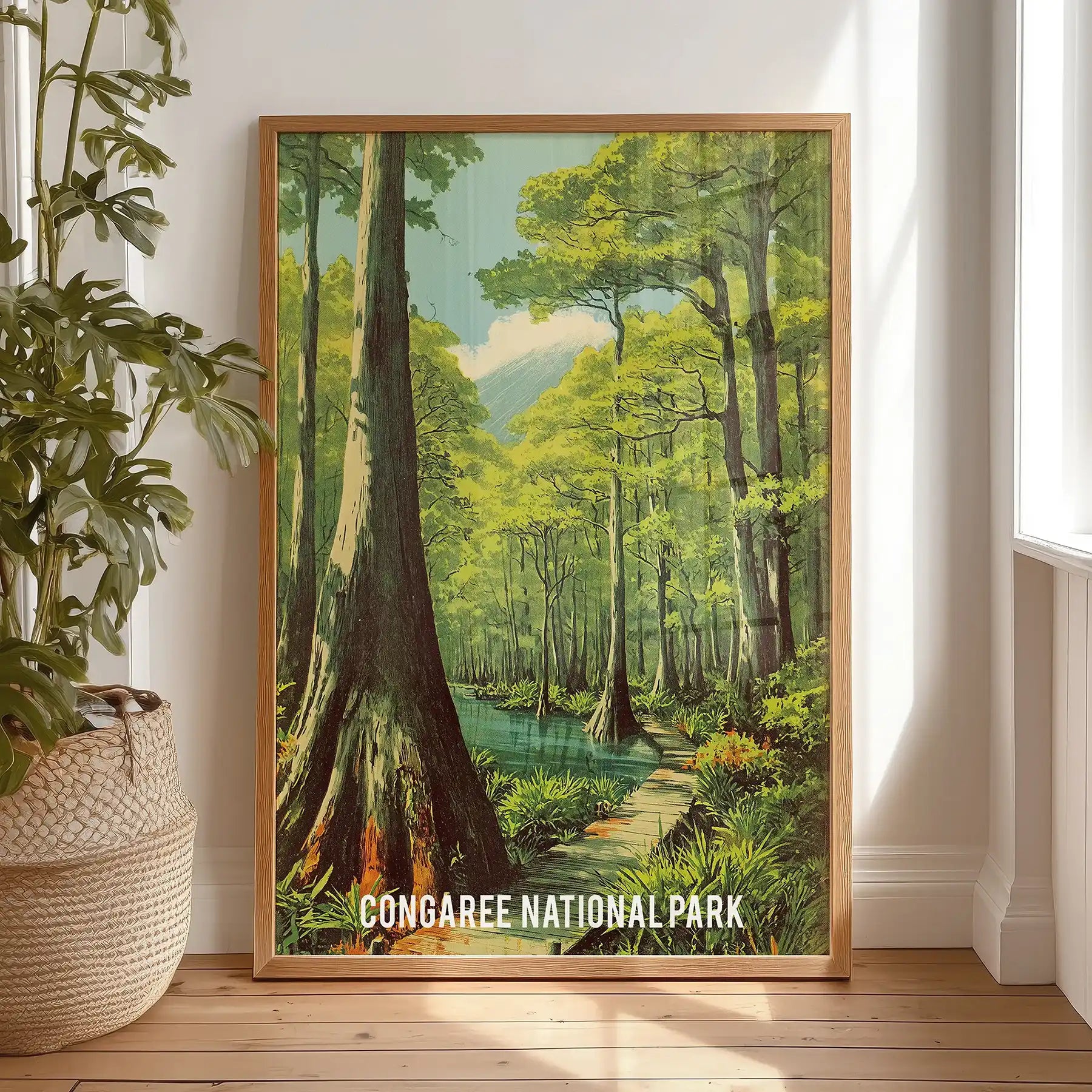 Boardwalk Loop trail large wall poster in a natural wood frame leans against the bedroom wall by the window, offering a sunlit path through Congaree.