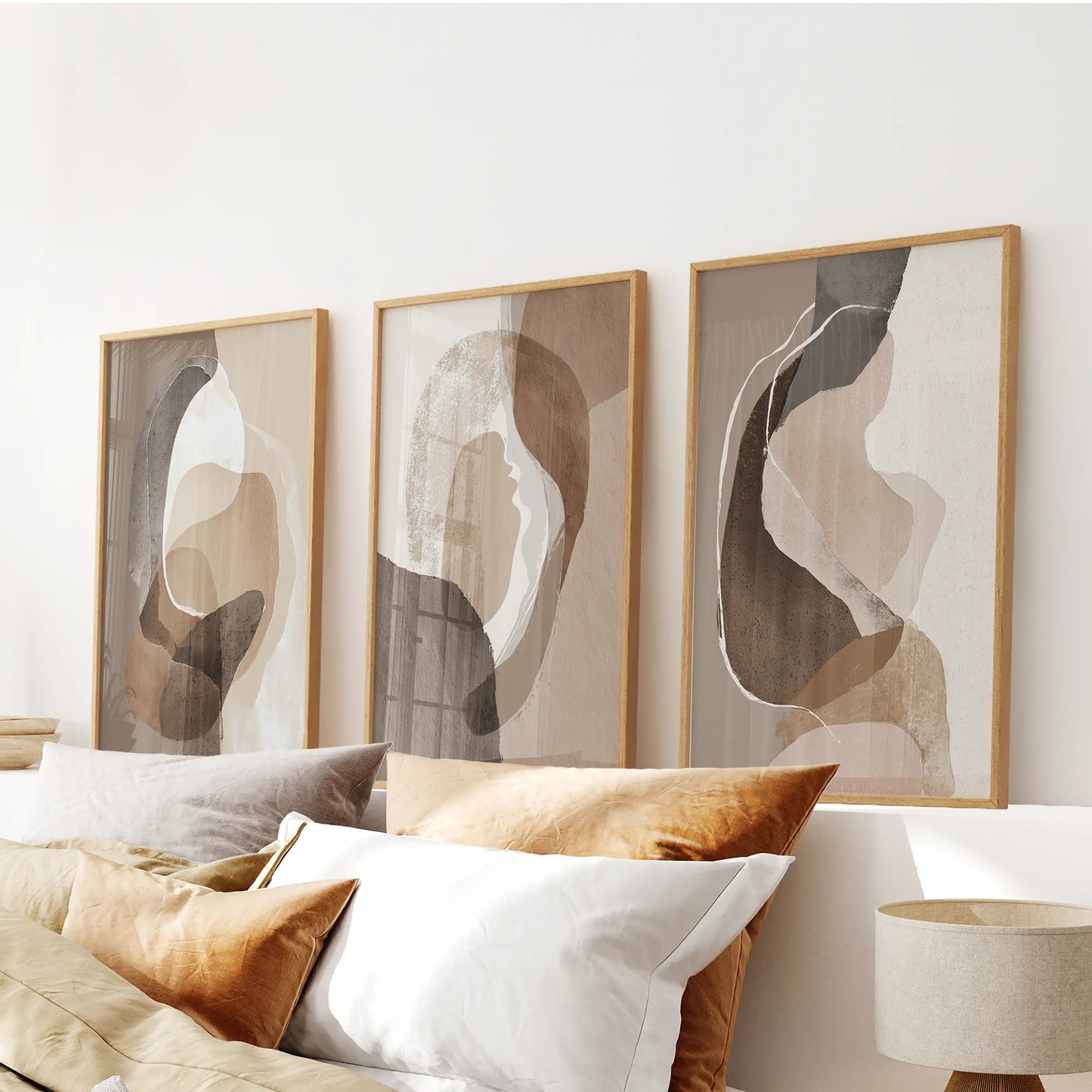 Earth-tone geometric prints three-piece art set, in oak frames, sits above the bed’s headboard to add calm, layered neutrals.