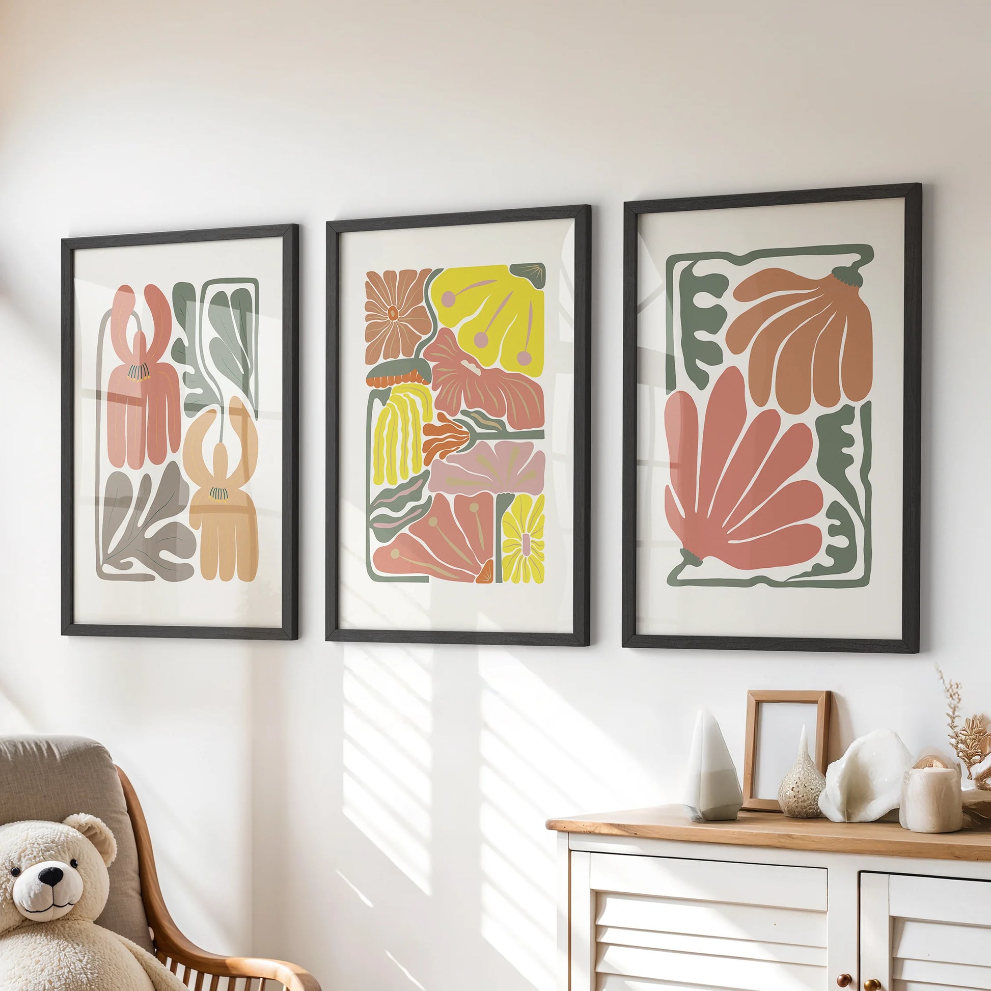 Boho flower market posters, a print trio, brighten the kids’ playroom above the chest of drawers, shown in slim black frames with playful terracotta botanicals.