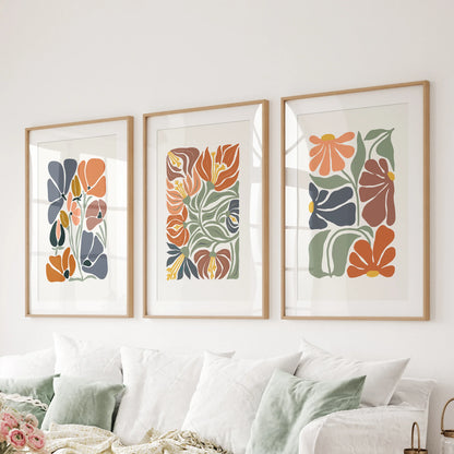 Matted wood-framed abstract florals in a 3-piece wall-hanging set layer organic shapes neatly behind the sitting-room couch.