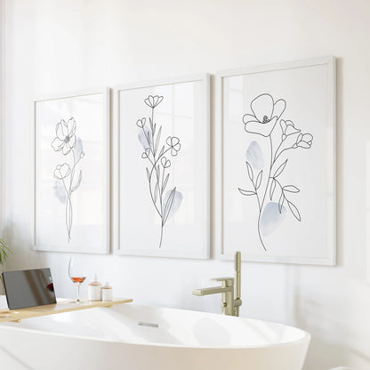 Pastel blue watercolor flowers, 3 wall art set, brings a soothing note to the bathroom over the tub in crisp white frames.