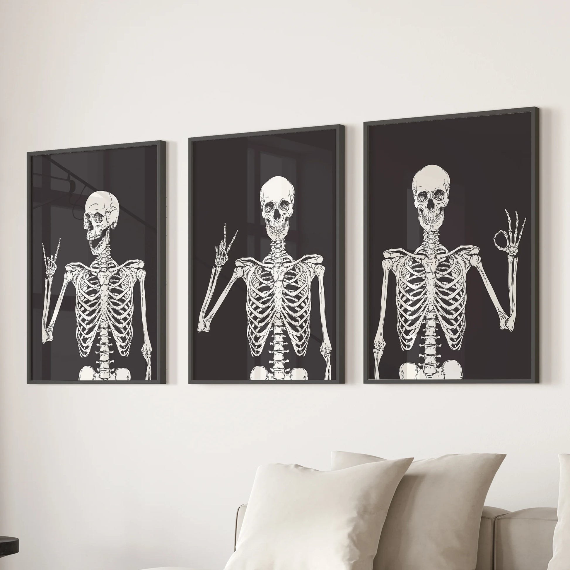 Black-framed skeleton prints in a 3-piece wall art collection lend the family room above the sectional sofa a light, spooky flair.