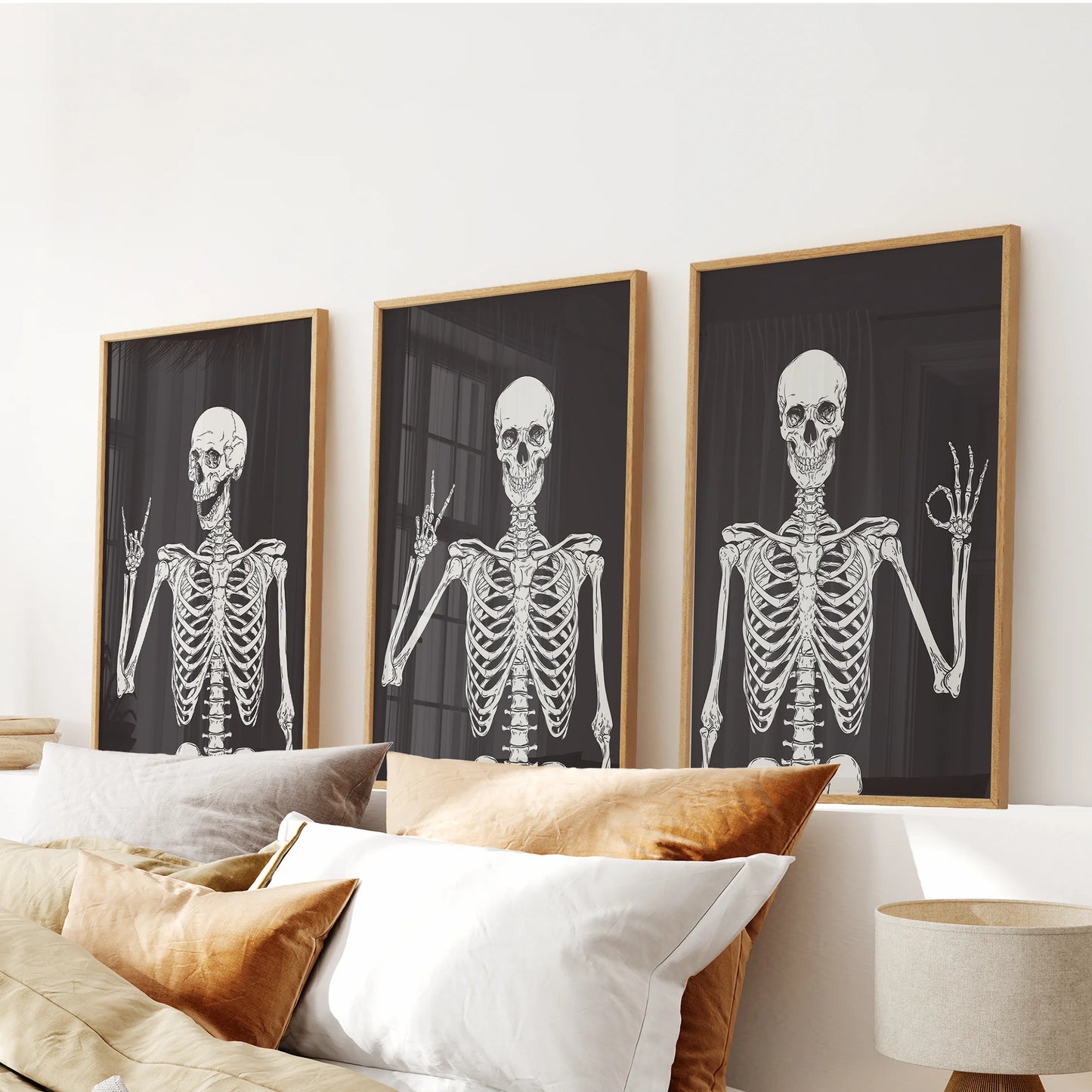 Sets of three oak-framed skeleton prints top the bedroom wall above the headboard, blending boho warmth with a gentle holiday accent.