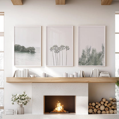 Boho palm trees 3-piece artwork crowns the lounge, paired with clean white frames and centered above the fireplace mantel.