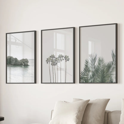 California coastal sunset poster trio brings warm, peachy light to the family room, in sleek black framed prints displayed over the sectional.