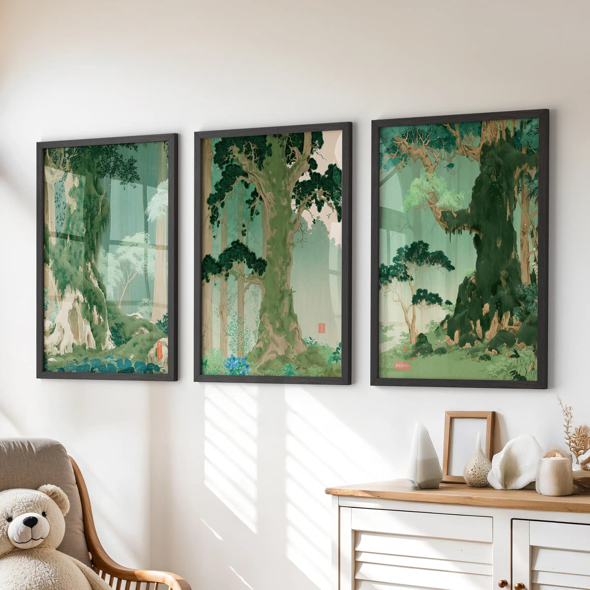Green botanical scenery wall art, a three-piece set in black frames, hangs over a chest of drawers in the playroom.