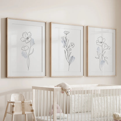 Abstract floral line sketches, 3 pc wall art set in wooden frames with mats, perches above the bassinet to soften the nursery room.