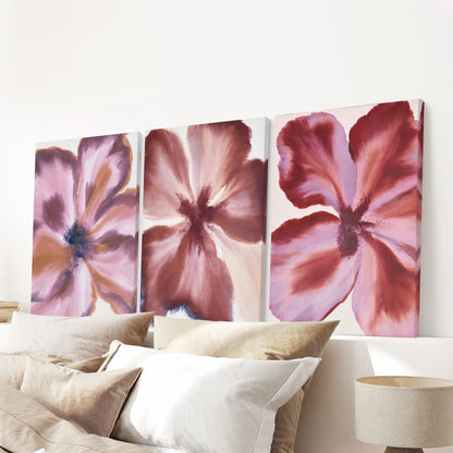 Broad wine-red petals with dusty pink and mauve highlights cover three separate canvases above the bed pillows.