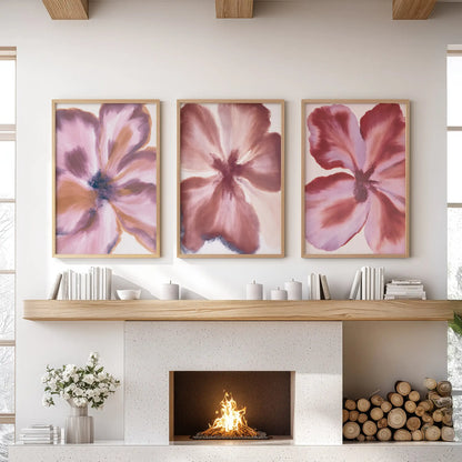 Dusty pink edges soften the wine-red petals in three oak-framed flower prints above the fireplace mantel.
