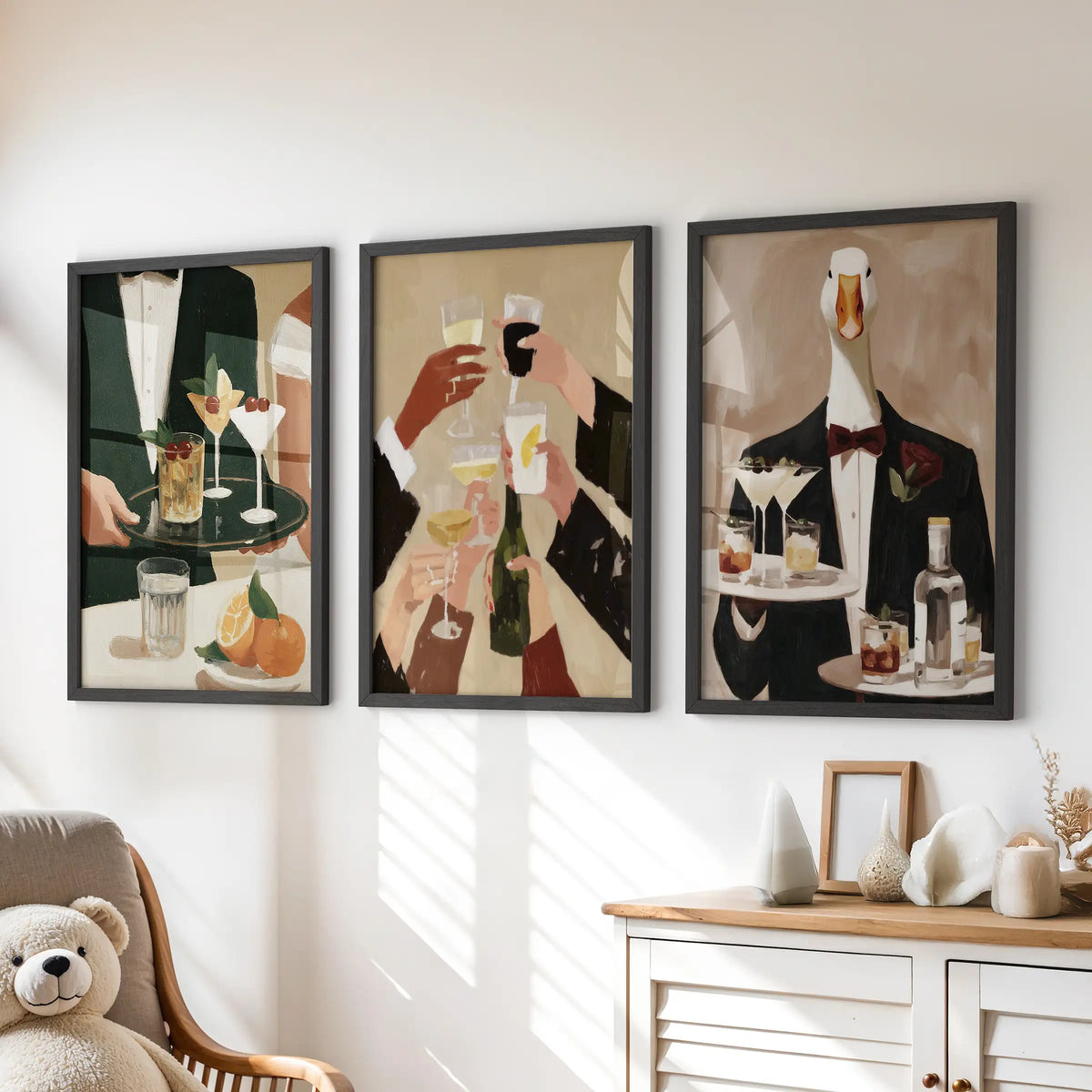 Cafe cocktail wall art in a three-print gallery set, displayed in black frames above a chest of drawers in a kids' playroom.