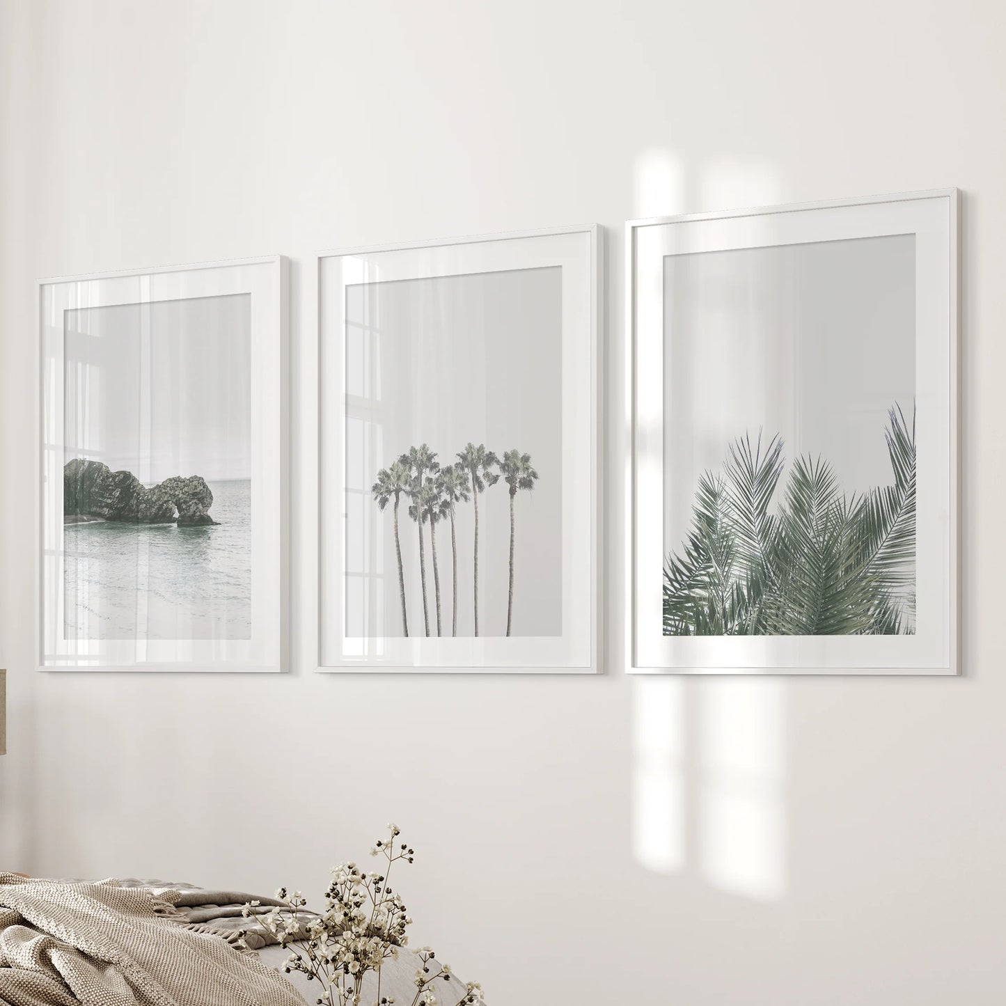 Pastel seaside landscape three-poster bundle brings gentle color to the bedroom, set in white mat frames and placed near the bed wall.