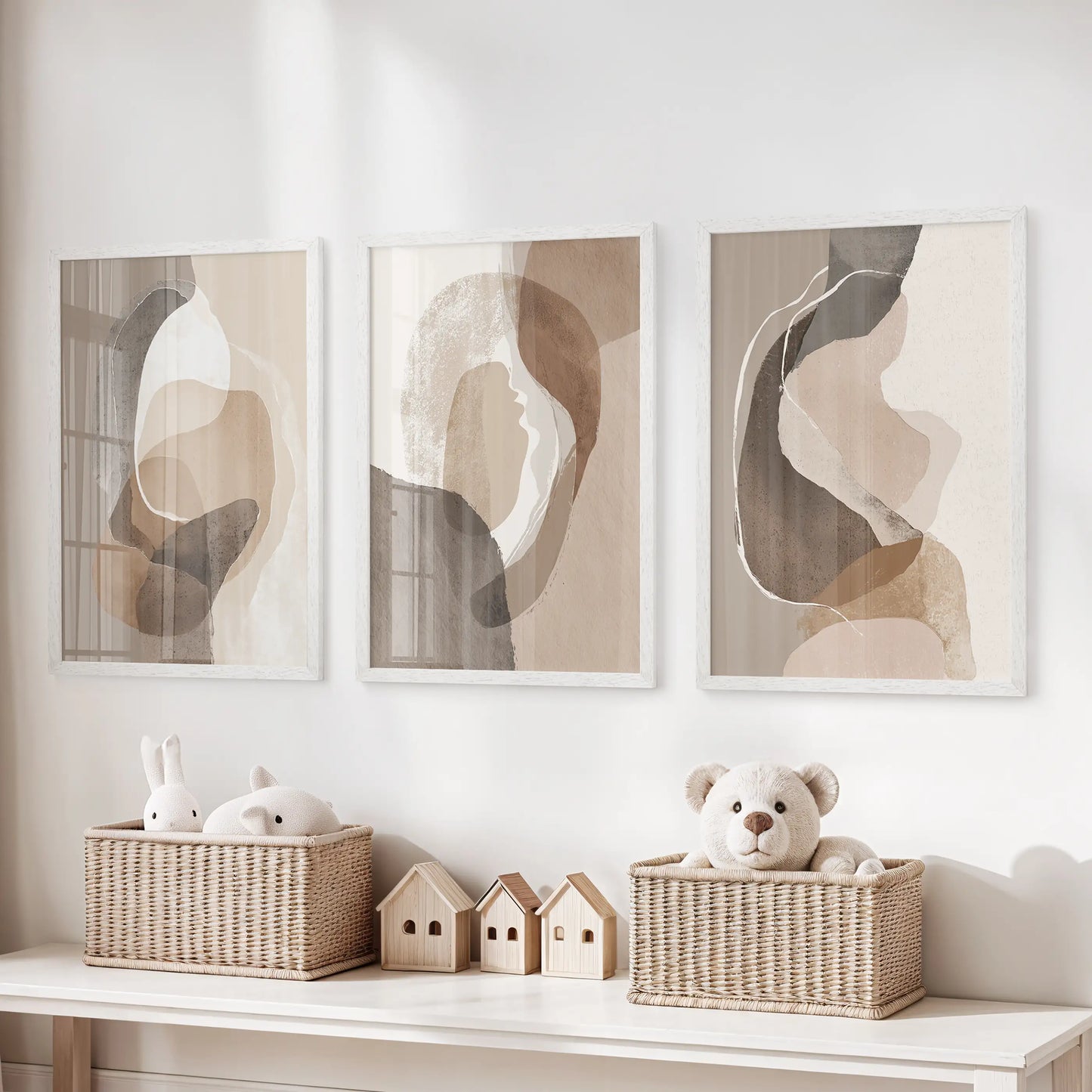 Beige and brown minimalist art set of three prints, white framed, hangs over the toy organizer to keep a kids playroom calm and cohesive.