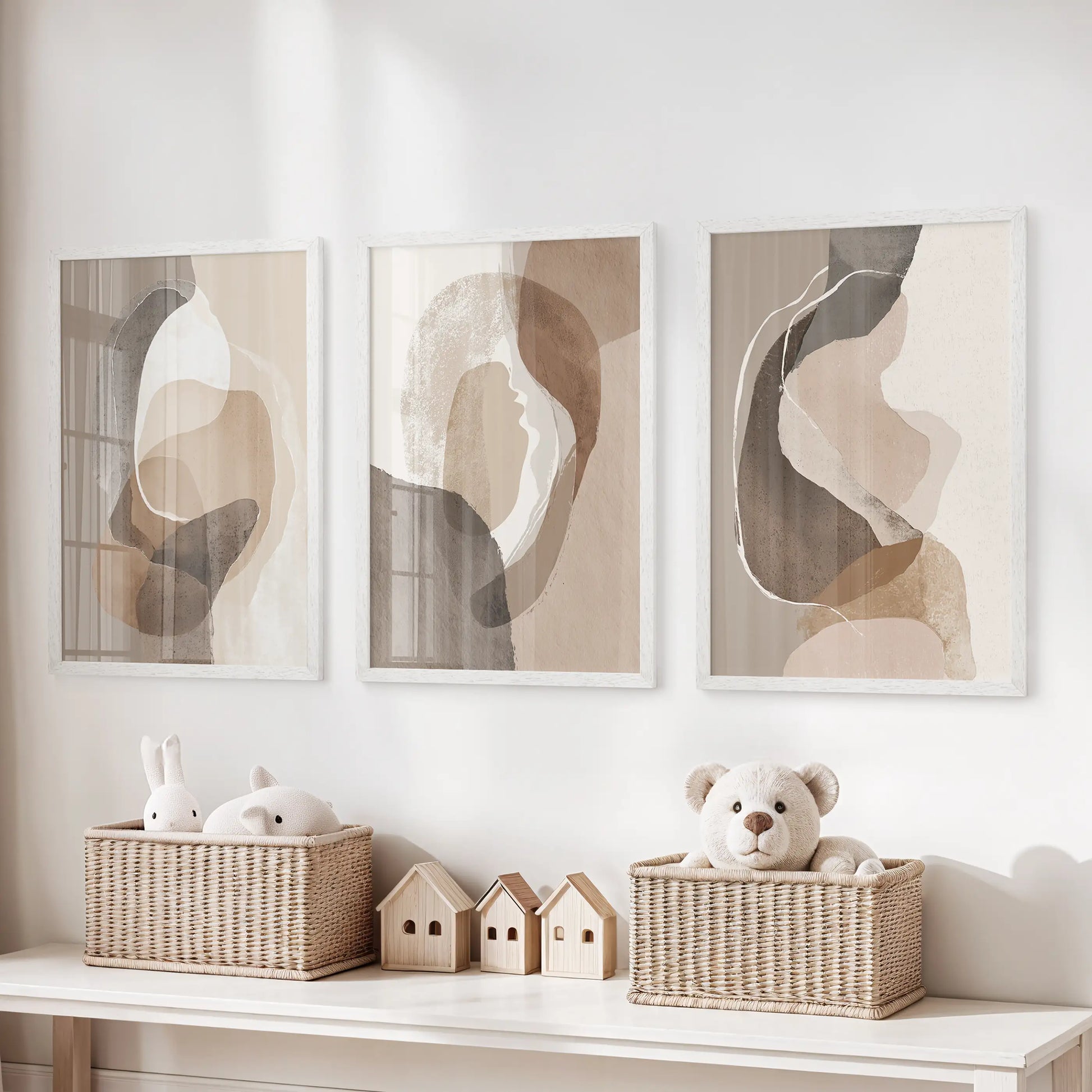 Beige and brown minimalist art set of three prints, white framed, hangs over the toy organizer to keep a kids playroom calm and cohesive.