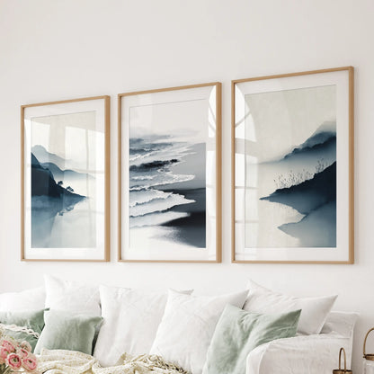 A 3-panel ocean scene spans the lounge above the sectional, wood-matted frames lending a tailored coastal refinement.