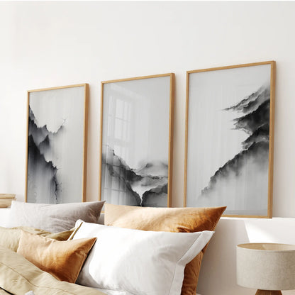 A 3-print wall art set of mountain silhouettes in light wood frames adds an easy calm above the bed in the bedroom.