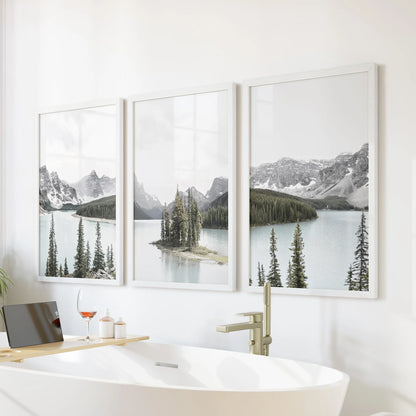 A three-print wall art set of the Canadian wilderness in white frames floats above the tub, lending the bathroom a calm, spa-like quiet.