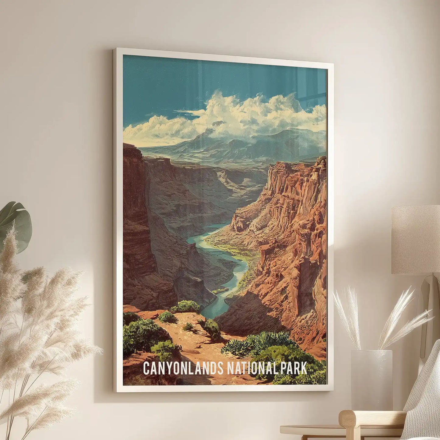 A desert canyon landscape poster in a white frame fills the living room with open Southwest light, positioned neatly above the chair.