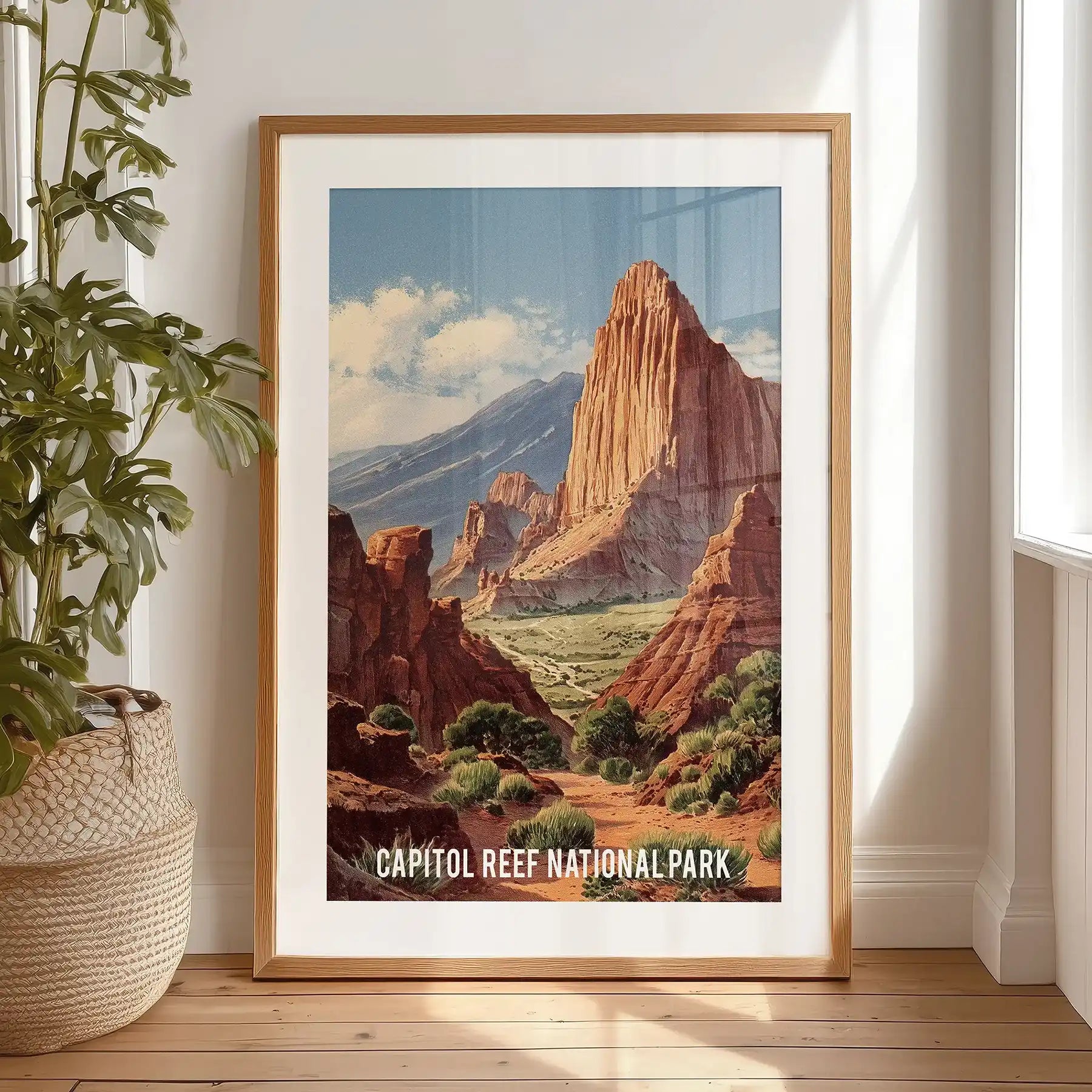 A black-matted Capitol Reef cliffs print, leaning casually on the bedroom floor, serves as refined wall art with easy design-forward charm.