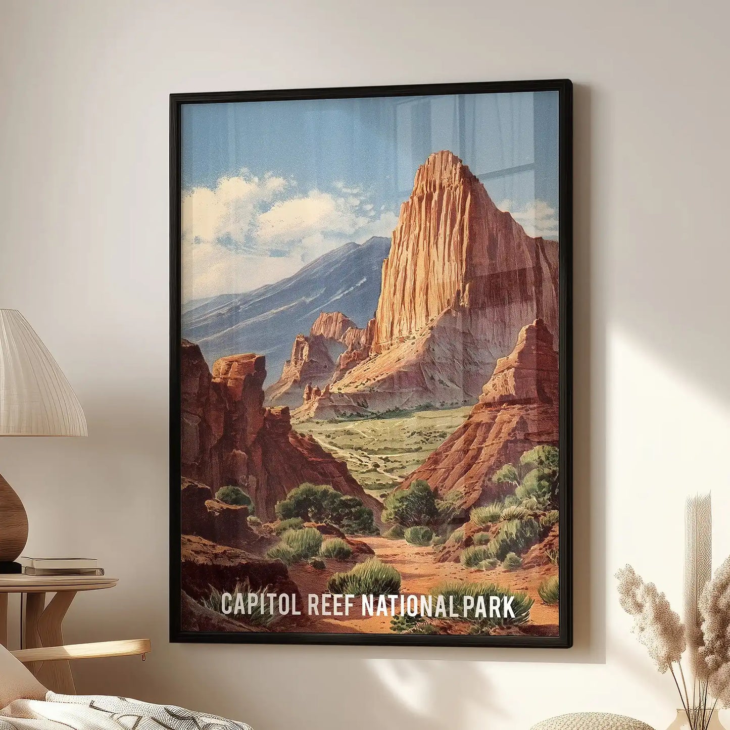 A black-framed wall art print of Capitol Reef’s rust-colored cliffs hangs above a family-room armchair, adding a modern calm to the space.