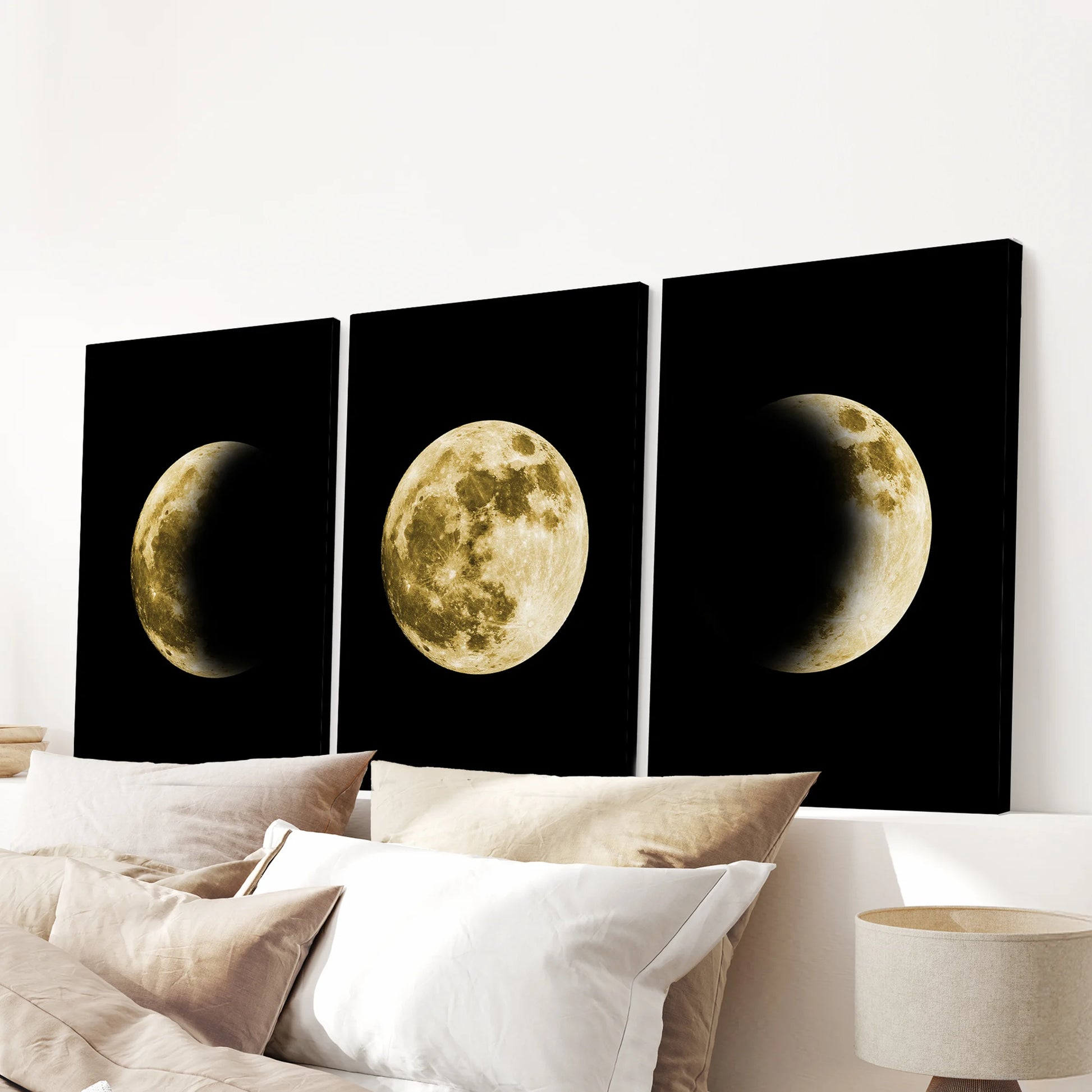 A gold moon phase triptych printed on gallery-wrapped canvas hangs above the headboard, bringing a tranquil celestial center to the bedroom.